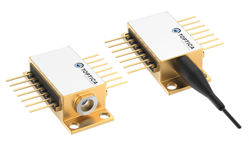 Two gold-colored electronic components with pins are shown. The left one has a cylindrical opening, and the right one is connected to a black cable.