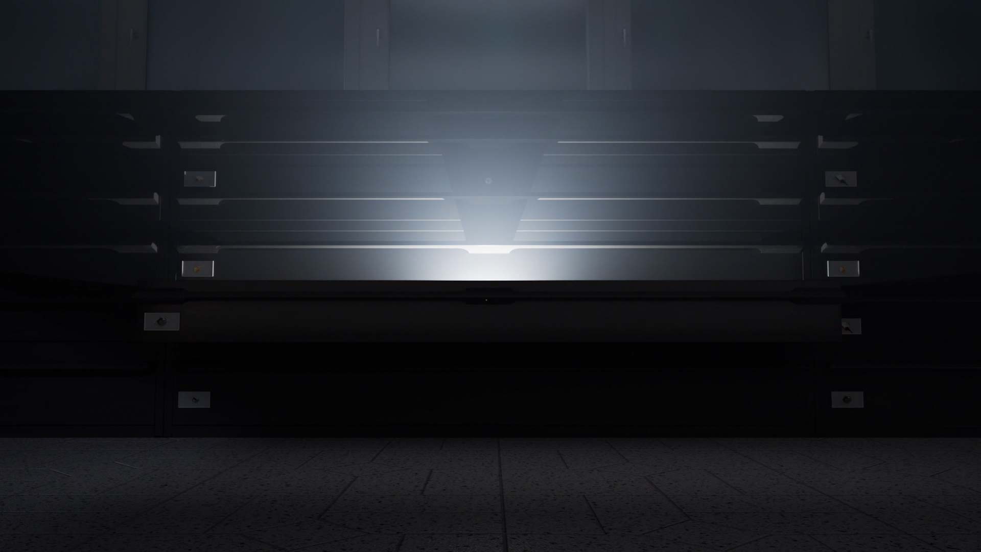 A dimly lit, empty refrigerator display case with metal shelves and a reflective glass front.